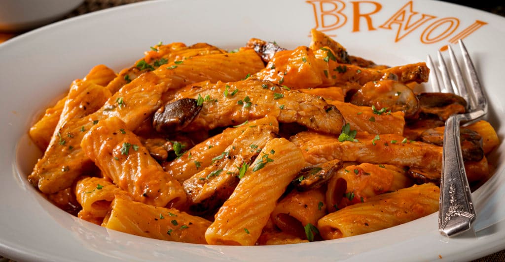 close up of pasta bravo in a plate with a fork