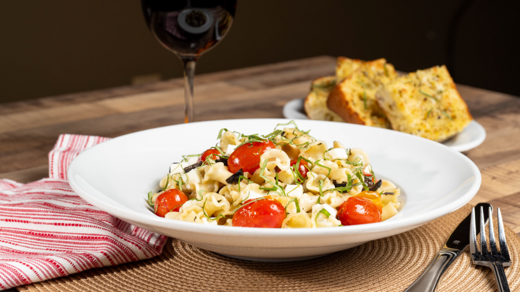 Campanelle pasta with tomatoes, mozzarella and basil.