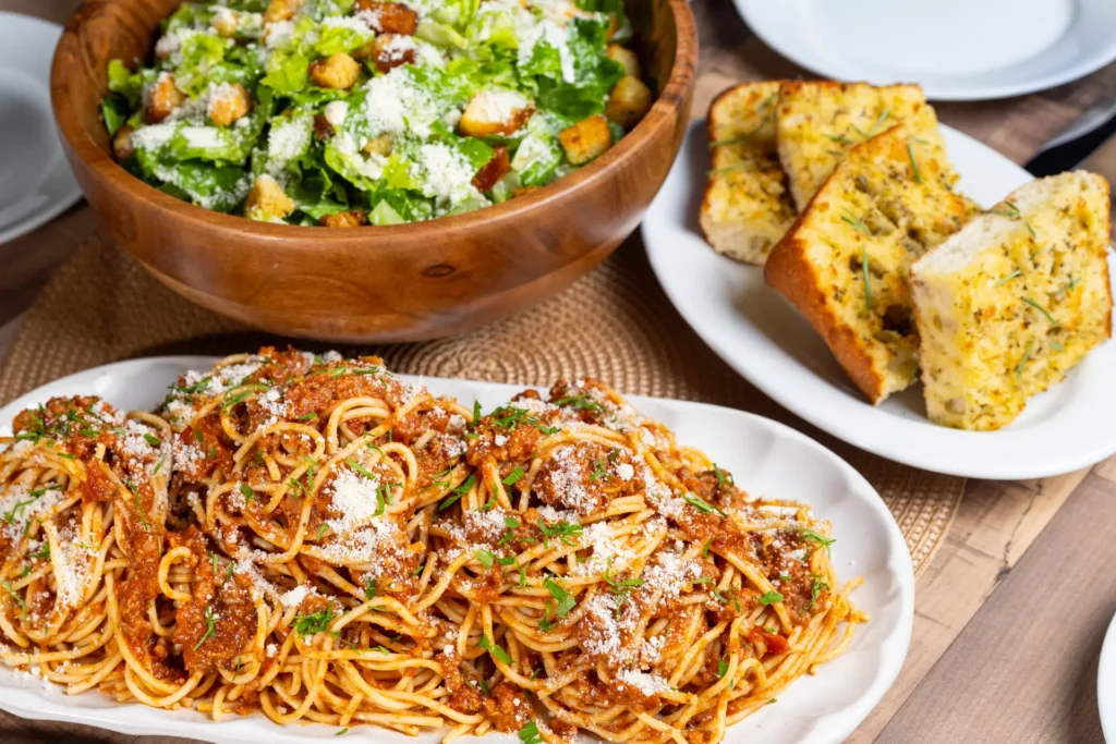 Spaghetti, Caesar salad and garlic bread served family style.