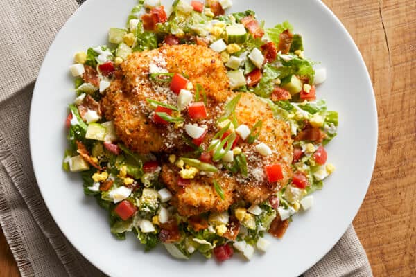 Closeup of Romano Crusted Chicken Salad in a white plate