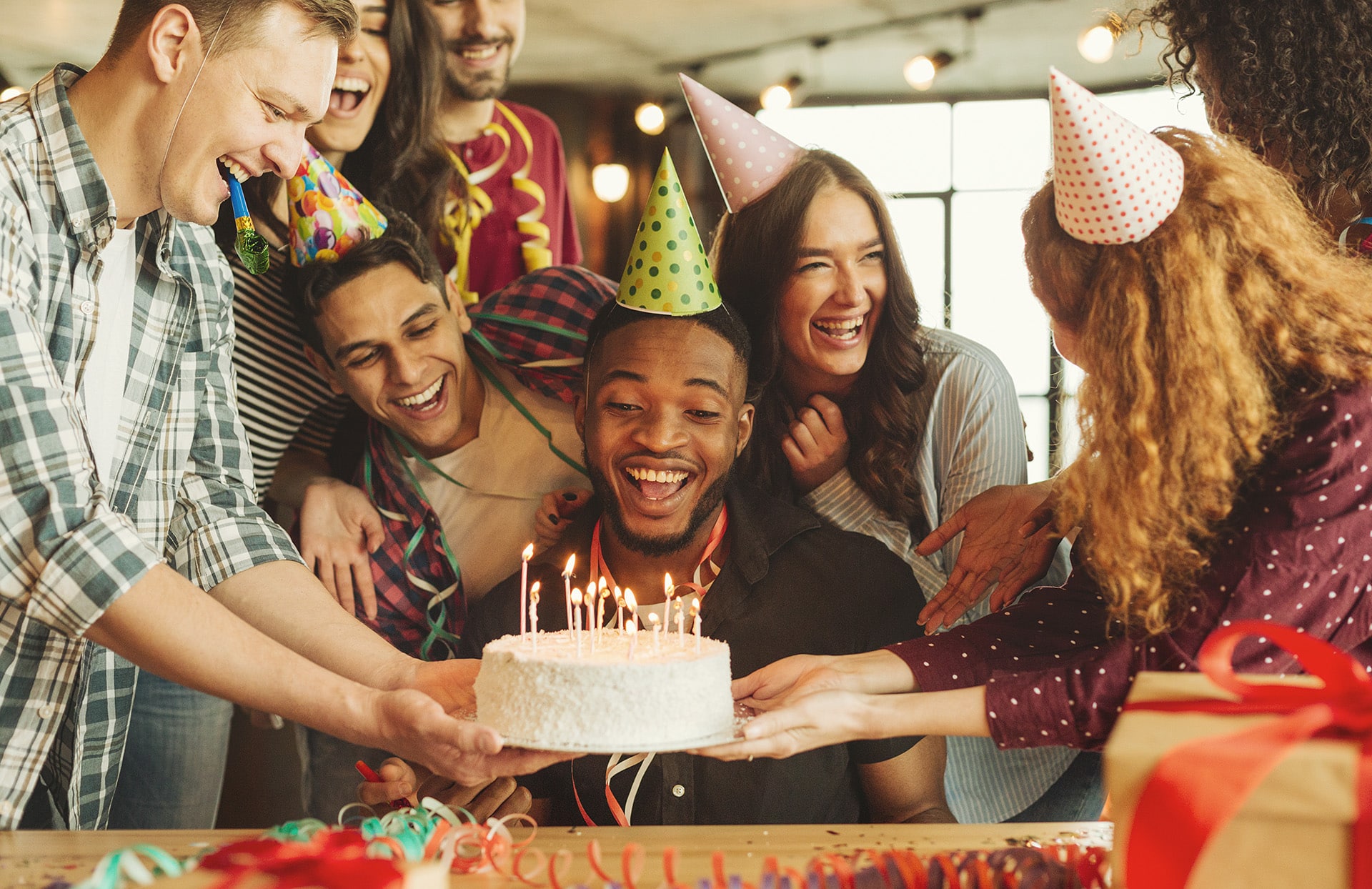 A birthday party at Bravo! with a cake and people with party favors