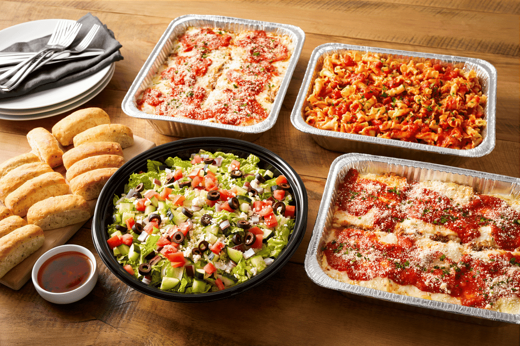 Bravo's catering pans with pasta, salad, and bread