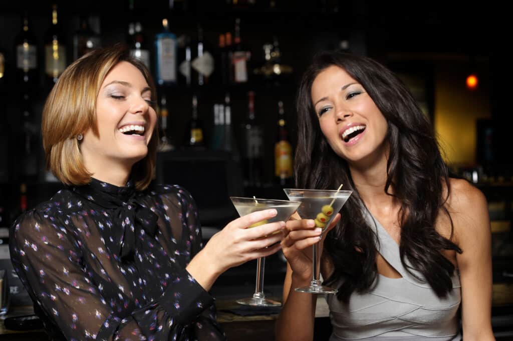 Two women enjoying drinks at Bravo!