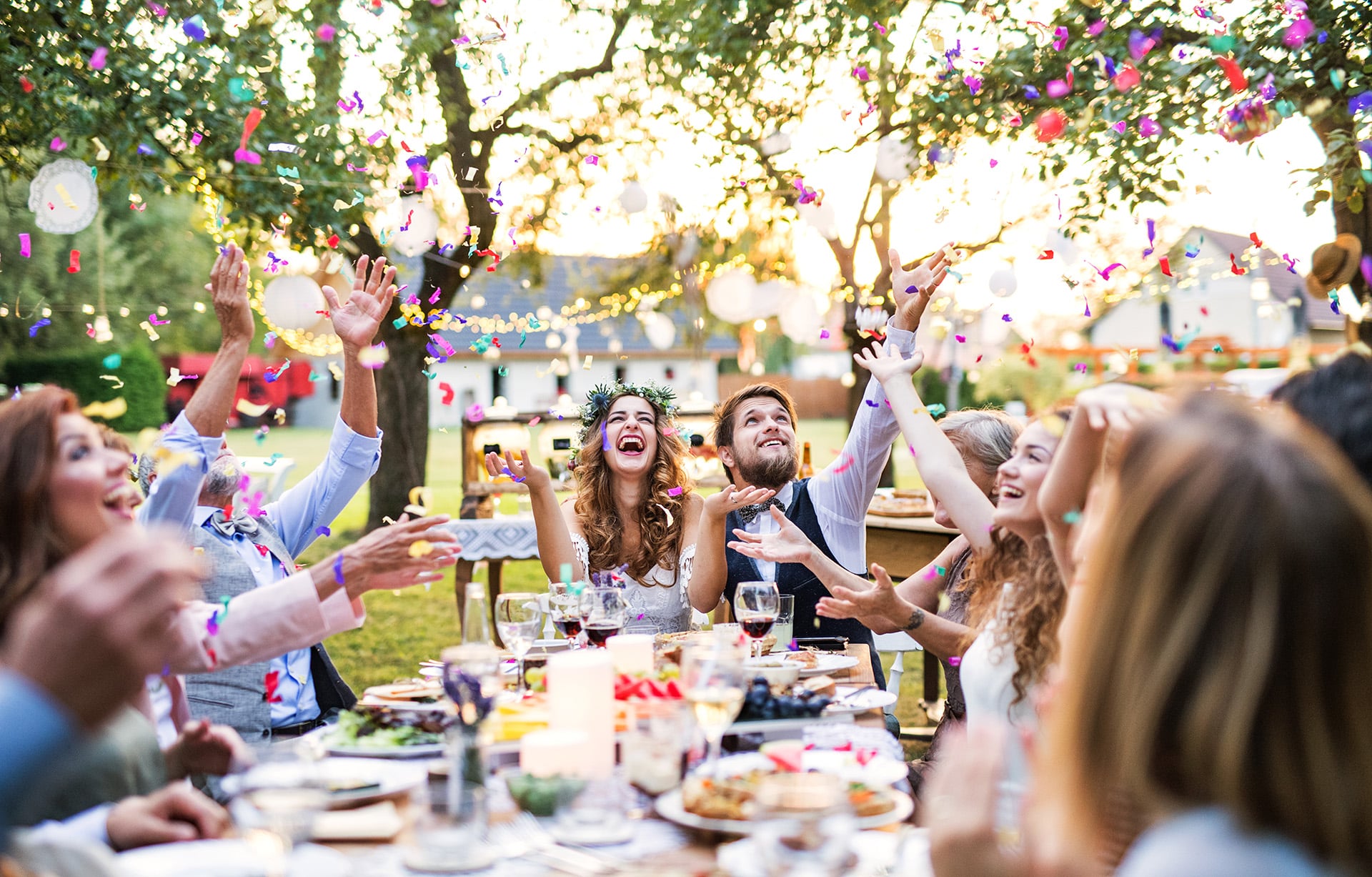 An outdoor wedding dinner event with confetti being catered by Bravo!