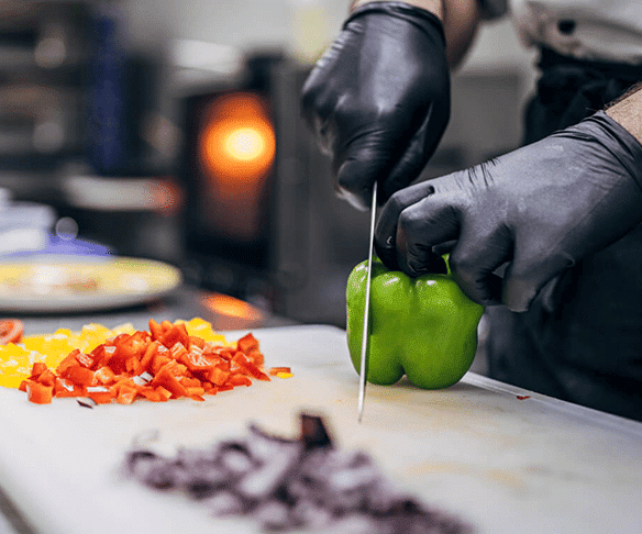 A photo of a chef preparing a pepper
