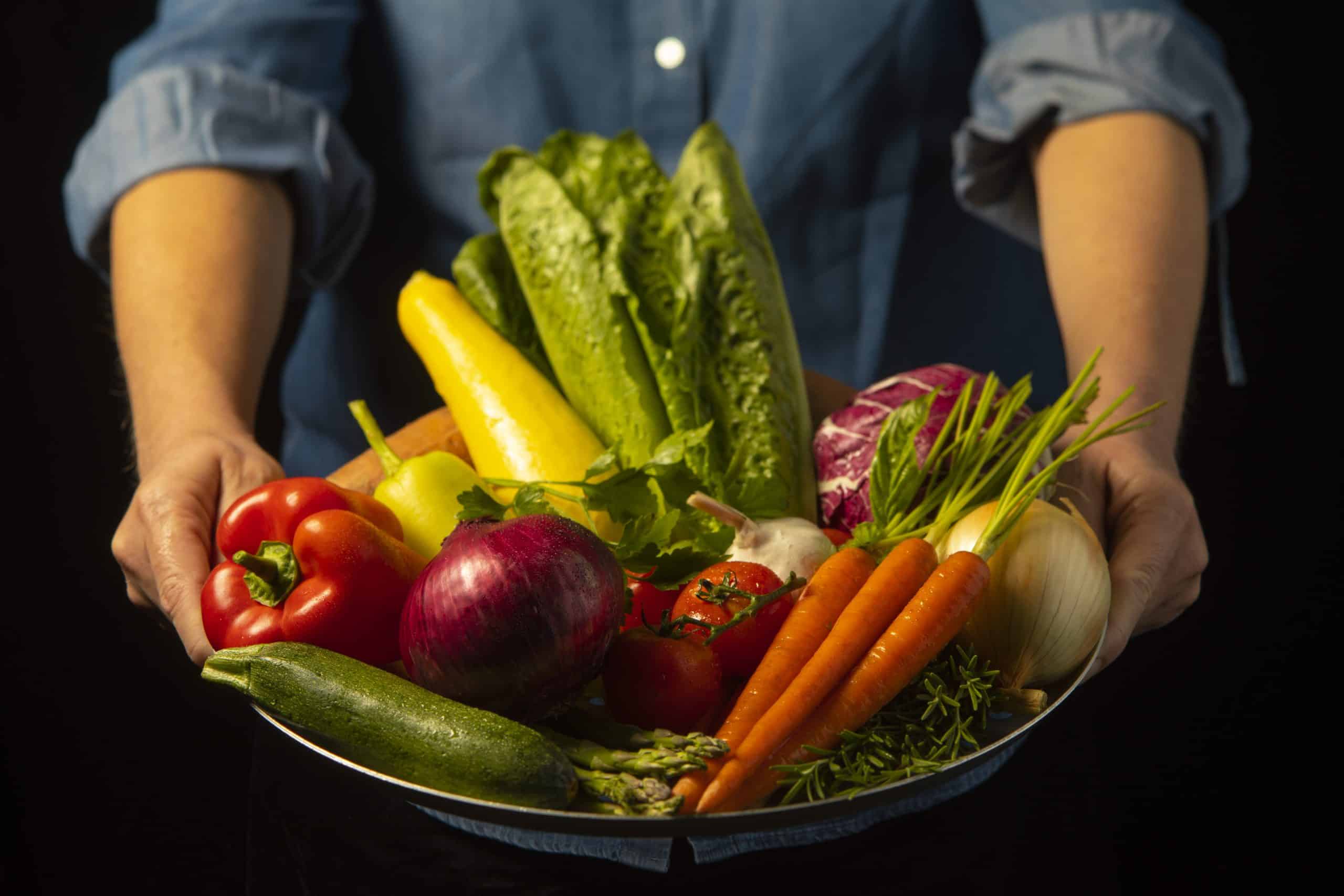 A Bravo Chef holding a basked of fresh ingredients