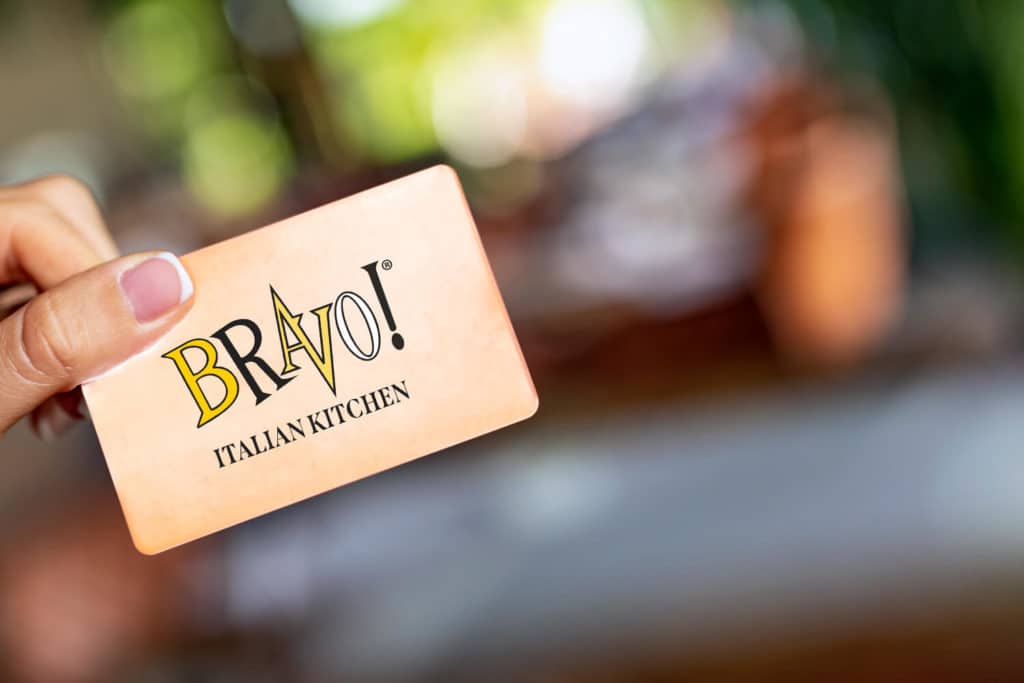 A photo of a hand holding a Bravo! gift card